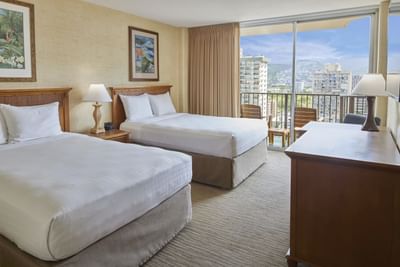 Two Double beds arranged by the private balcony in City View at Waikiki Resort Hotel by Sono