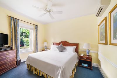 hotel suite with large bed and yellow walls