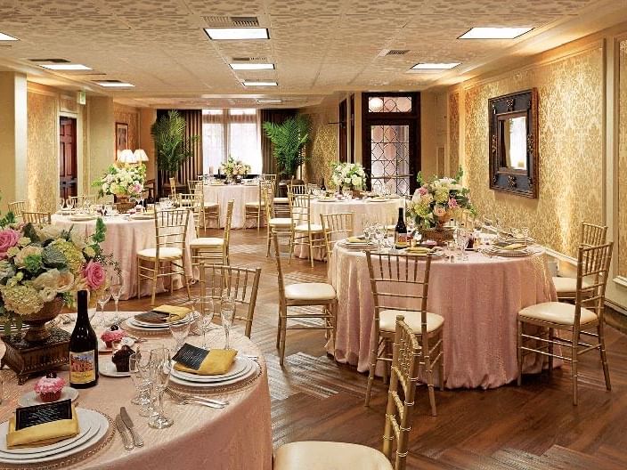 Mission Inn ballroom with decorated tables, chairs and flower centerpieces
