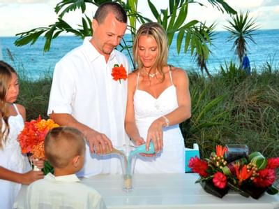 Bride and groom in ceremony at Windsong Resort On The Reef