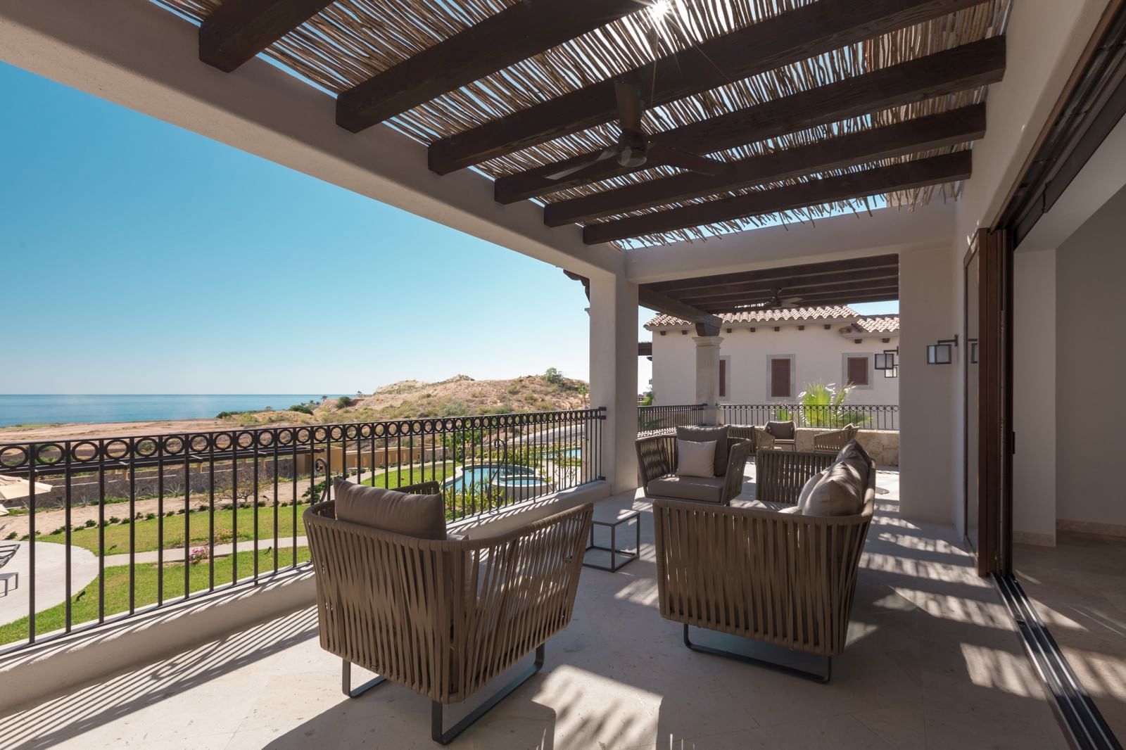 Cozy chairs by a room balcony at Live Aqua Private Residences Los Cabos