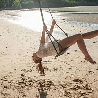 Girl swinging high at the Blue Lagoon Beach Port Dickson