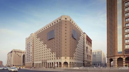 Grand exterior view of Saja Warwick Madinah Hotel with traditional architecture and arches