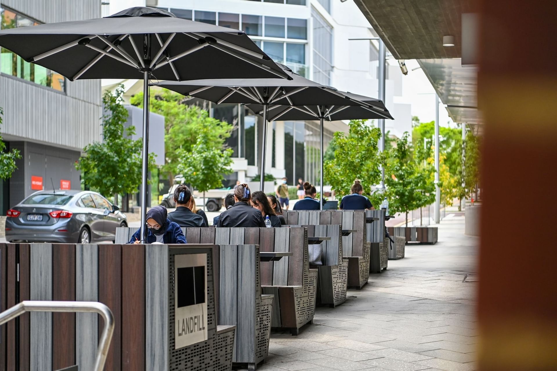 People dining & lounging outdoors at Nesuto Curtin Perth Hotel