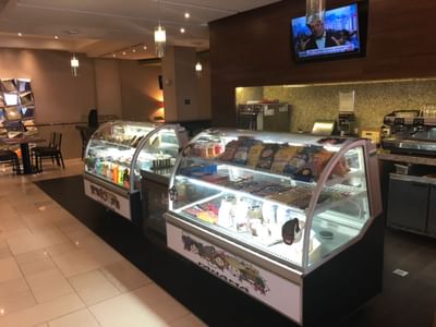 MARINN Restaurant with display cases containing desserts and beverages, and coffee machine at MARINN PLACE Financial District