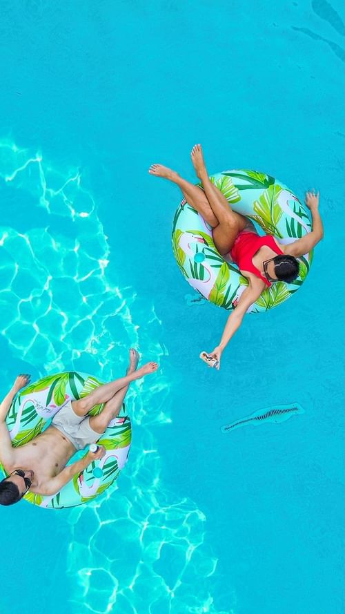 Top view of people enjoying the swimming pool at Warwick Hotels and Resorts