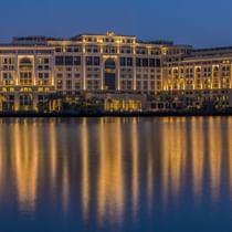 Exterior view of hotel by the river at night at Palazzo Versace
