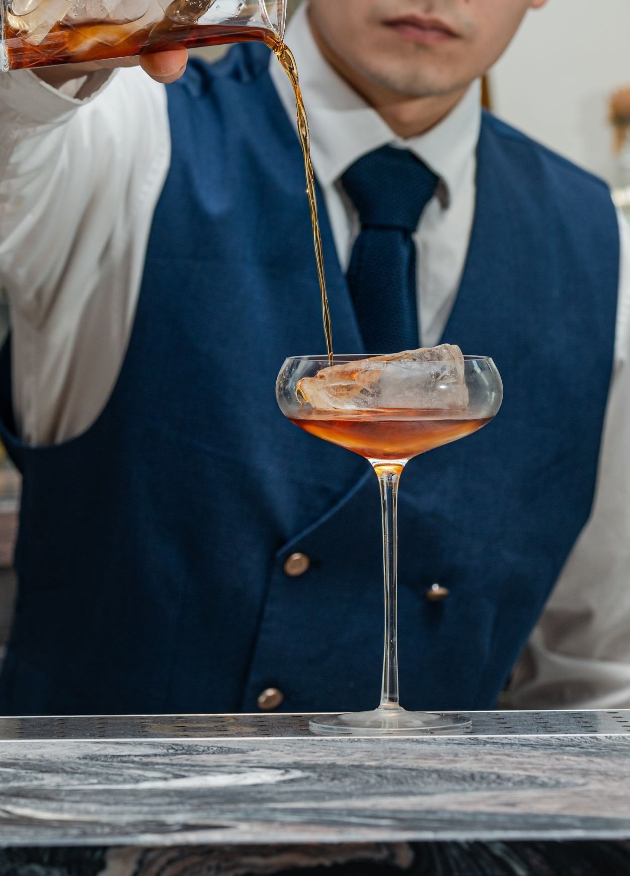 Close-up of a bartender making cocktail at The Londoner