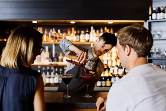 Bartender serving cocktails at Hazards Bar in Freycinet Lodge