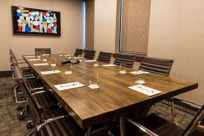 boardroom with long table and rolling desk chairs