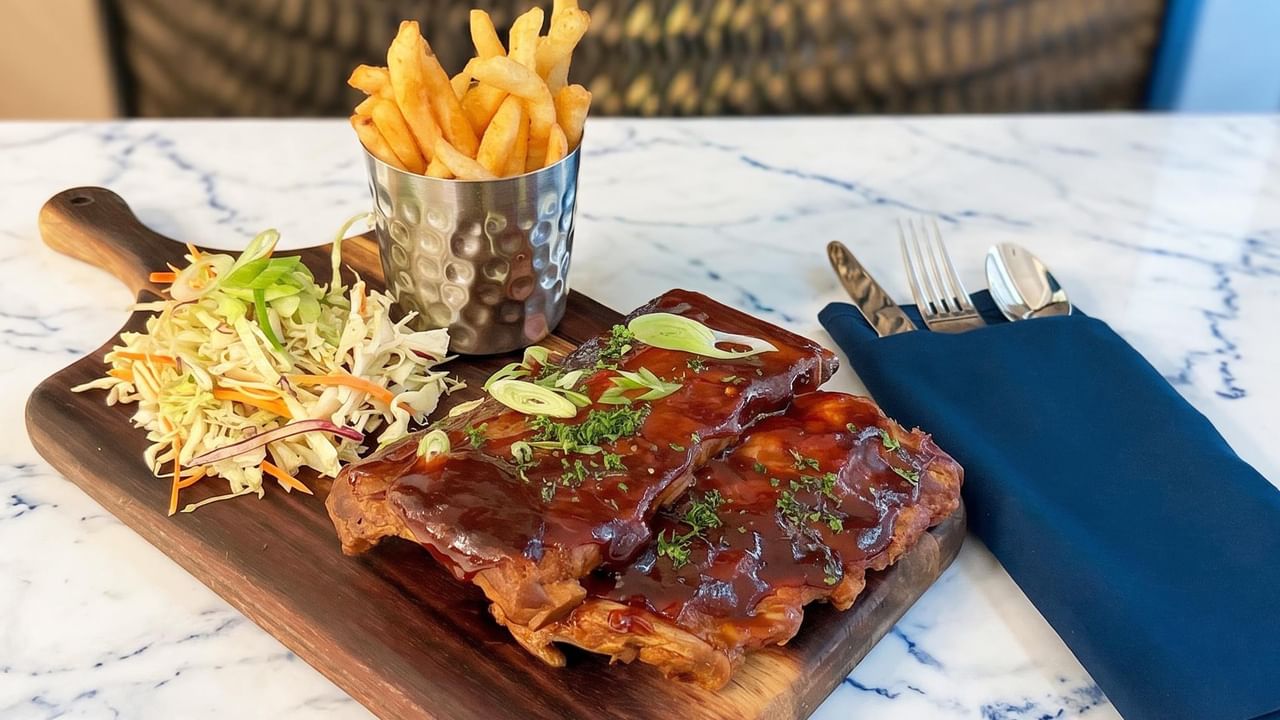 Glazed barbecue ribs with coleslaw and fries