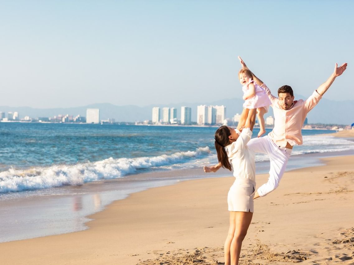 Woman holding their baby near the beach at Playa Los Arcos