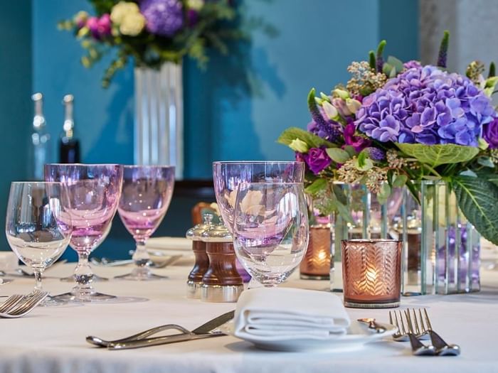 Floral centerpiece with candles on a table in Eaton Suite at The Capital Hotel, Apartments and Townhouse