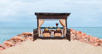 The beachfront exterior of Kupuri Spa with massage beds at Plaza Pelicanos Grand Beach Resort