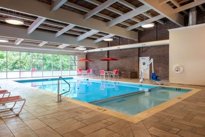 Indoor pool area with lounge area at White River Inn and Suites, one of the best hotels in white river Jct Vt