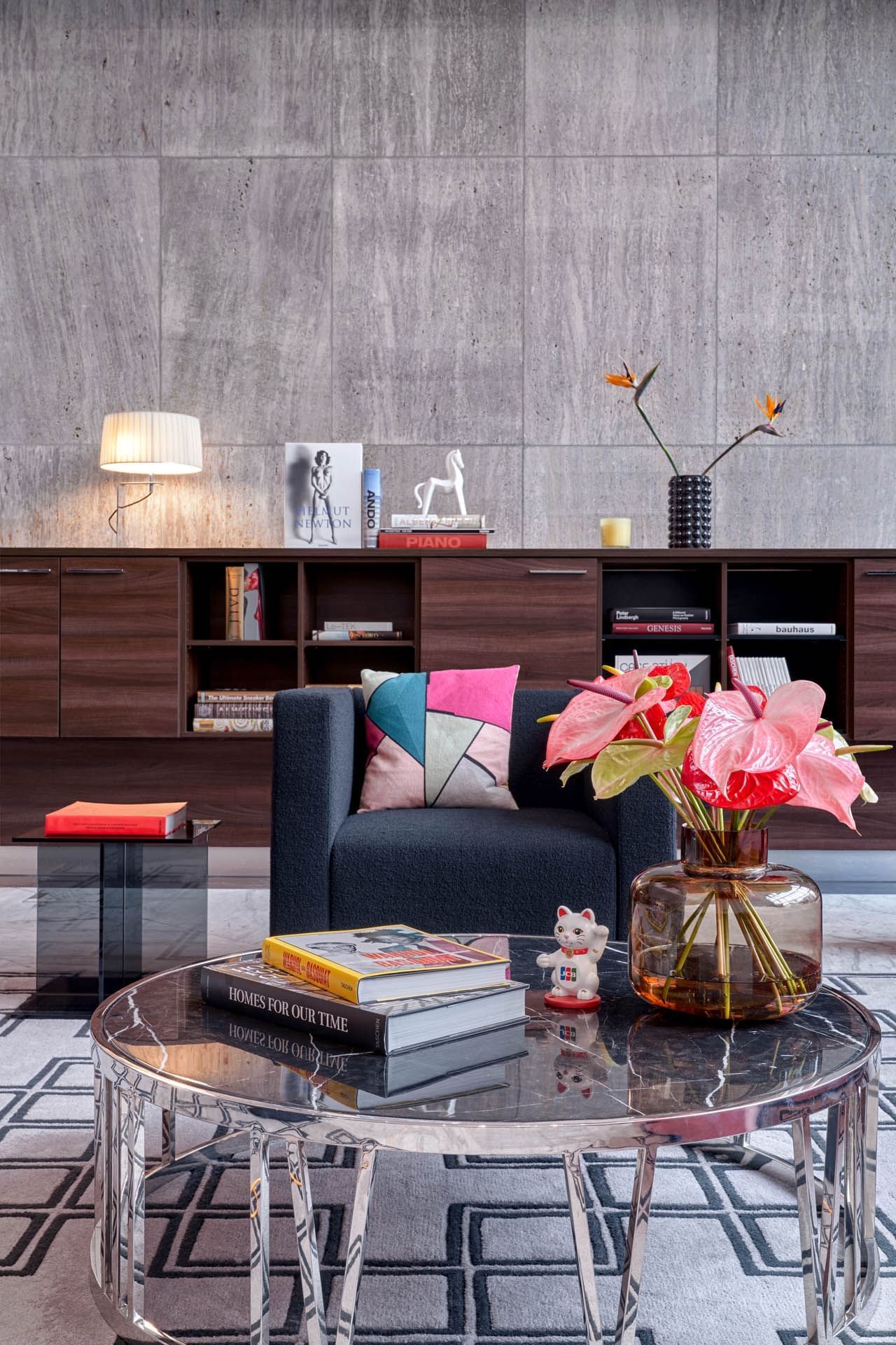 Couch & a table with some books in a lobby at Flemings Hotels