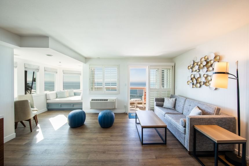 Hotel suite with couch, lamp and ocean view