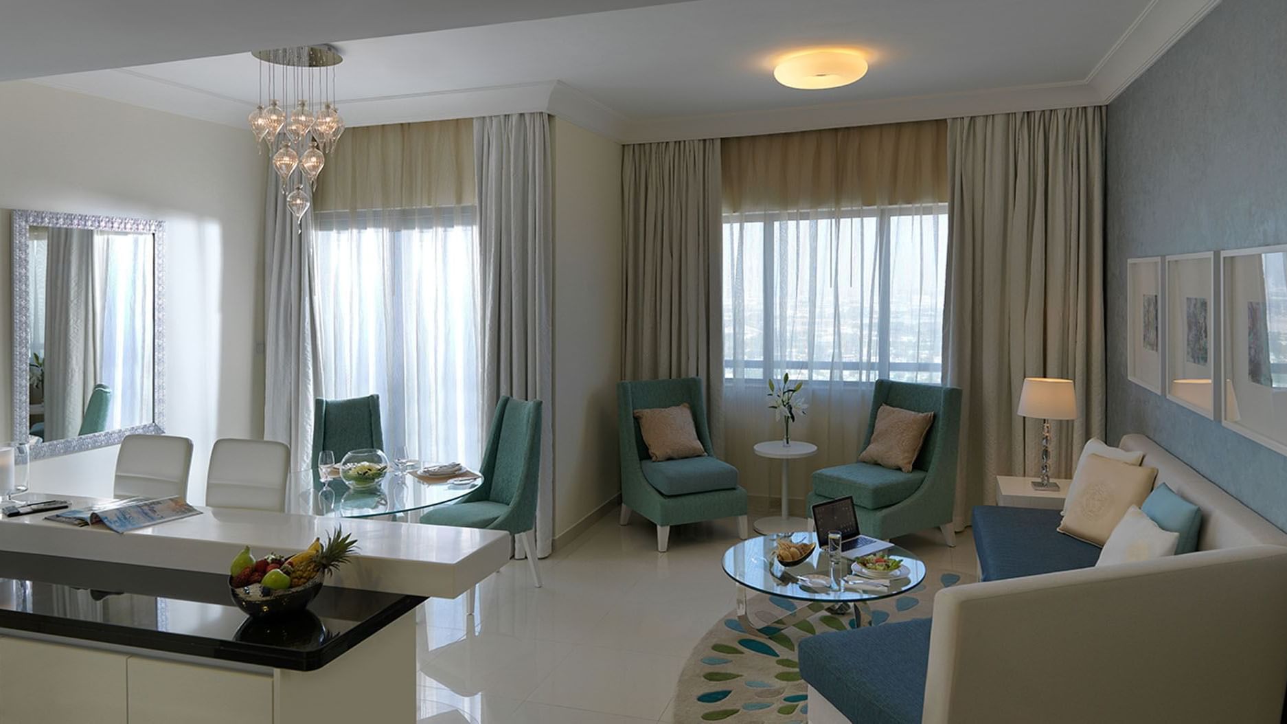 Lounge area with dining table in a room at Damac Maison Dubai Mall Street
