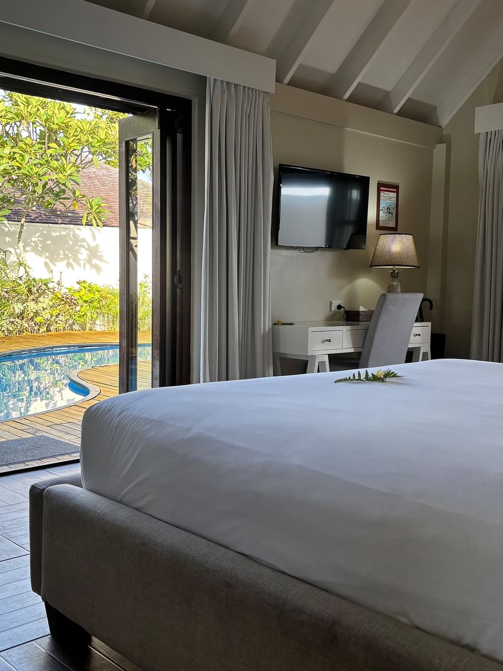 Pool villa bedroom with king-sized bed and private pool view at Warwick Le Lagon Efate.