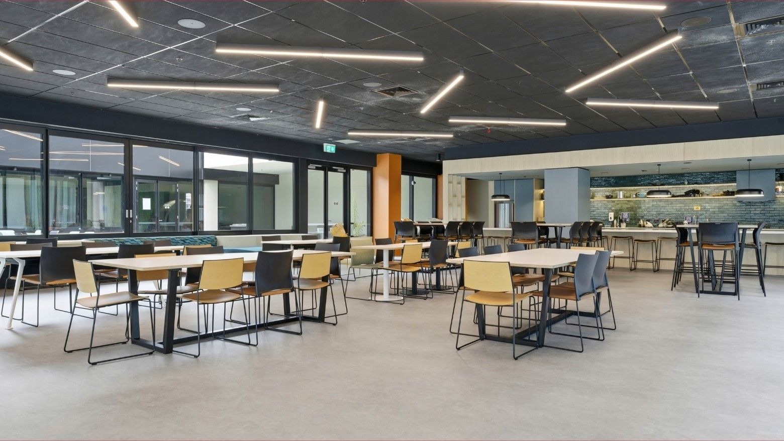 Spacious dining area with numerous tables and chairs, modern decor at Mayoral Drive Student Accommodation.