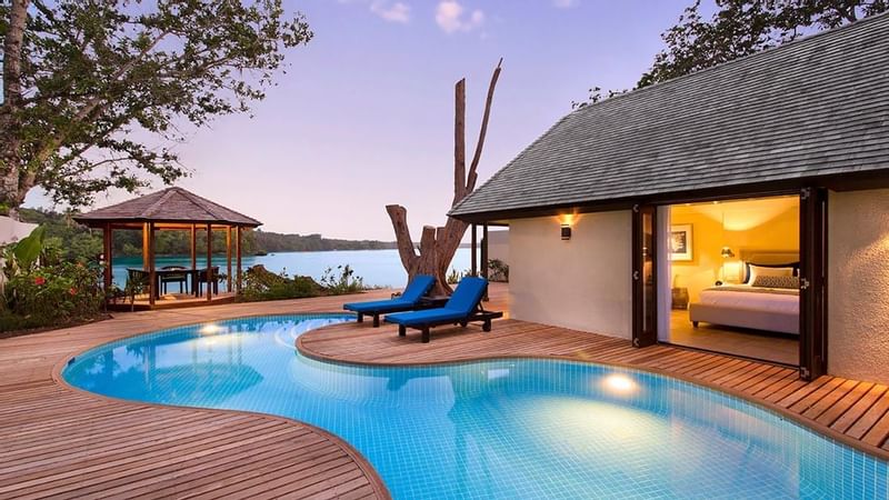 Sunbeds by the outdoor pool in Efate Vila at Warwick Le Lagon