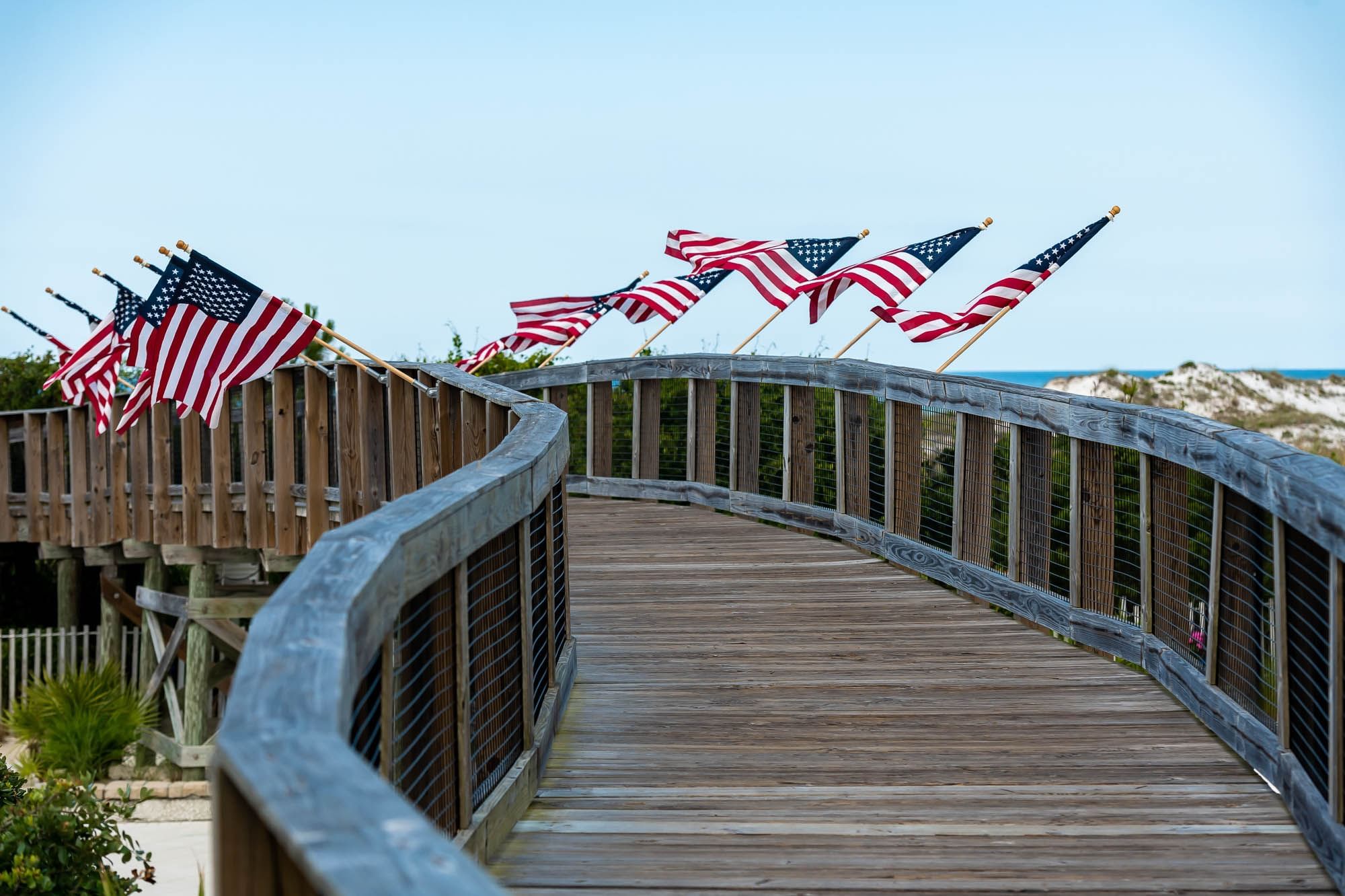 The Watersound Beach Club boardwalk lined with American flags