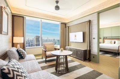 Comfy sofa, TV & city view in one bedroom suite at Eastin Hotels