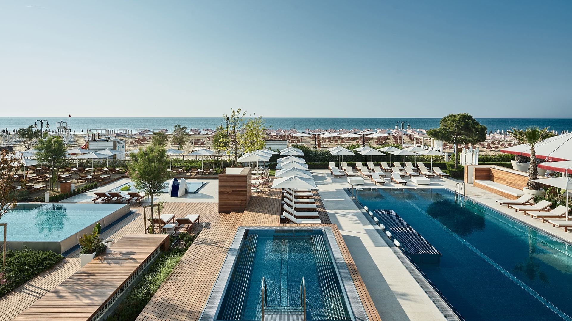 Aerial view of pool area by sea at Falkensteiner Jesolo