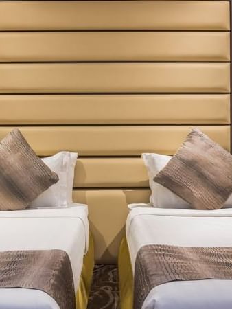 Standard King / Twin Bed features Two beds by nightstands with lamps at Naviti by Warwick Al Khobar