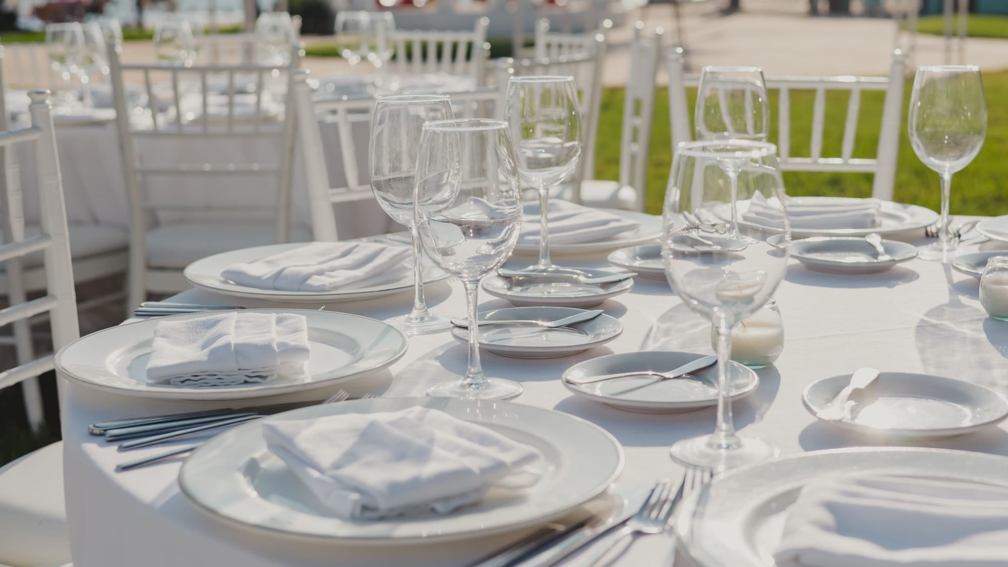 Elegantly set table with white linens and glassware at Fiesta Americana Riviera Nayarit Resort & Spa.