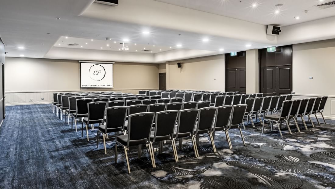 Woddriff room set up with rows of chairs and a screen at Event Centre at Panthers near Mercure Penrith in Penrith.