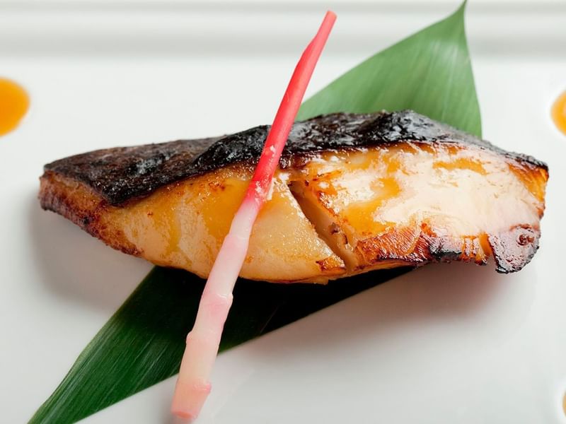 Seared fish fillet on a green leaf served in Nobu Restaurant at Crown Hotel Melbourne