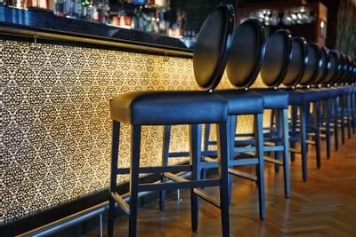 stools line a bar area