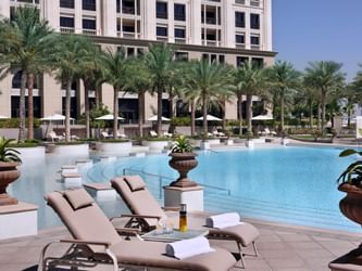 Sunbeds & palm trees by the pool at Palazzo Versace Dubai