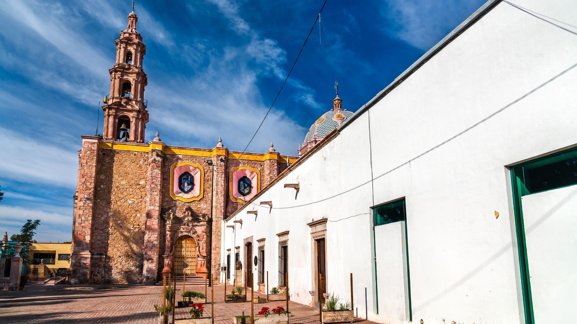 Museo José Guadalupe Posada exterior with a tall bell tower and white walls near Quinta Real Aguascalientes