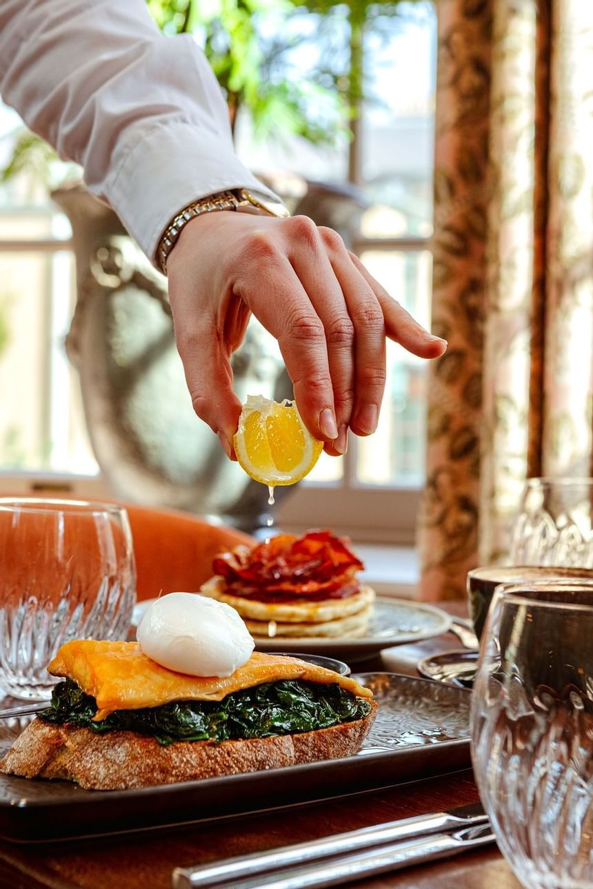 A waiter presenting a dish at a table in Richmond Hill Hotel