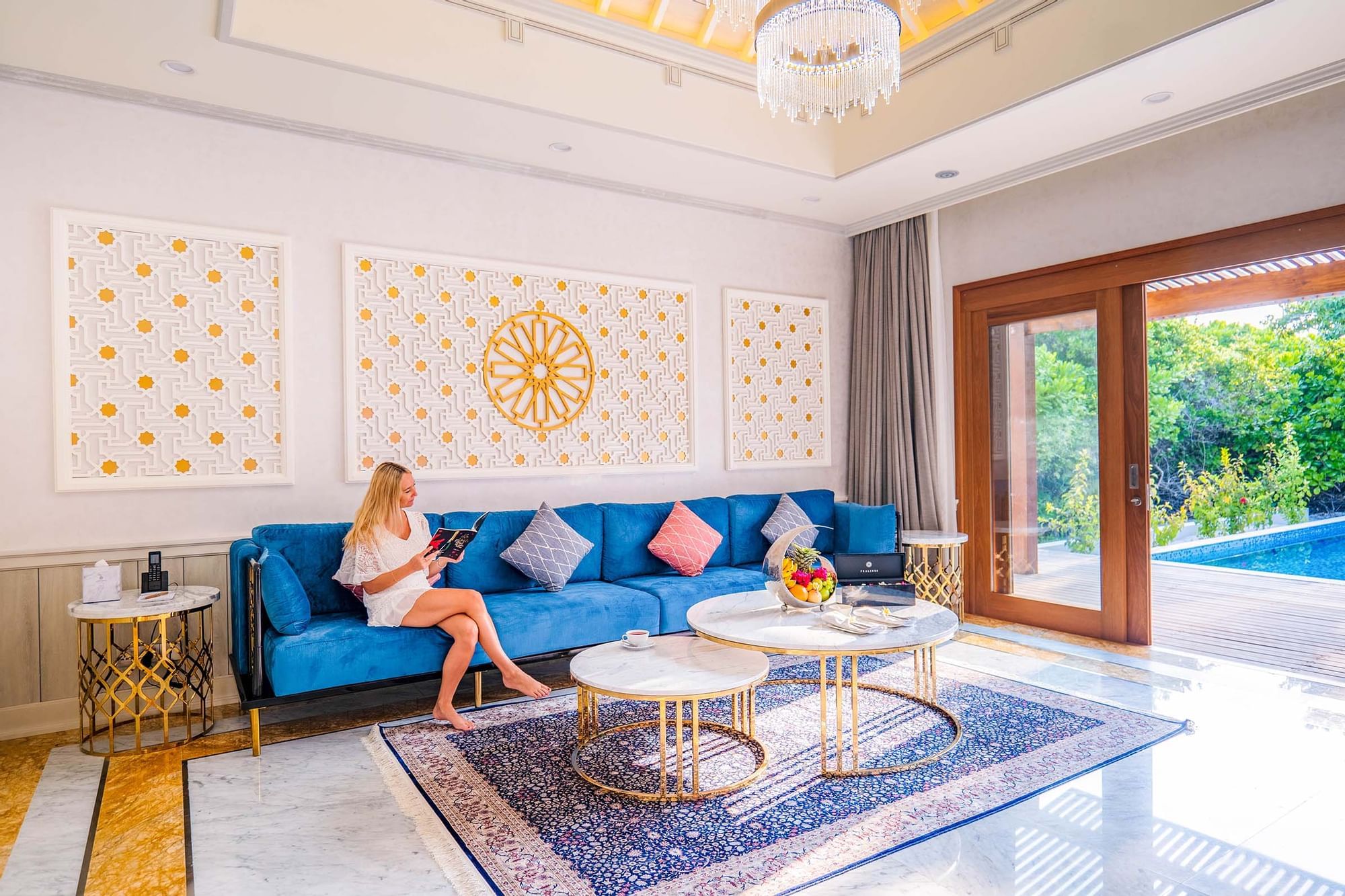 Lady reading a book in a living area, The Signature Collection