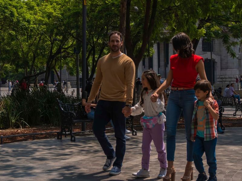 A family of four walking together near Fiesta Americana