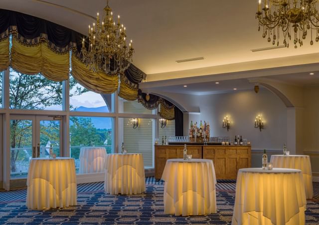 Presidential Ballroom with lit high-boy tables & a wooden bar under elegant chandeliers at Mountain View Grand Resort & Spa