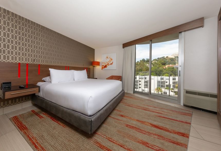 Los Angeles hotel West Coast King Room featuring a king-size bed, modern decor, a large window with a view at Hotel Angeleno