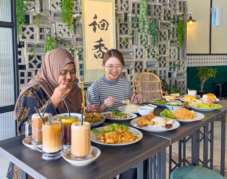 Two women enjoying a meal together at a restaurant at Sunway Boulevard 88 near Sunway Hotel Big Box