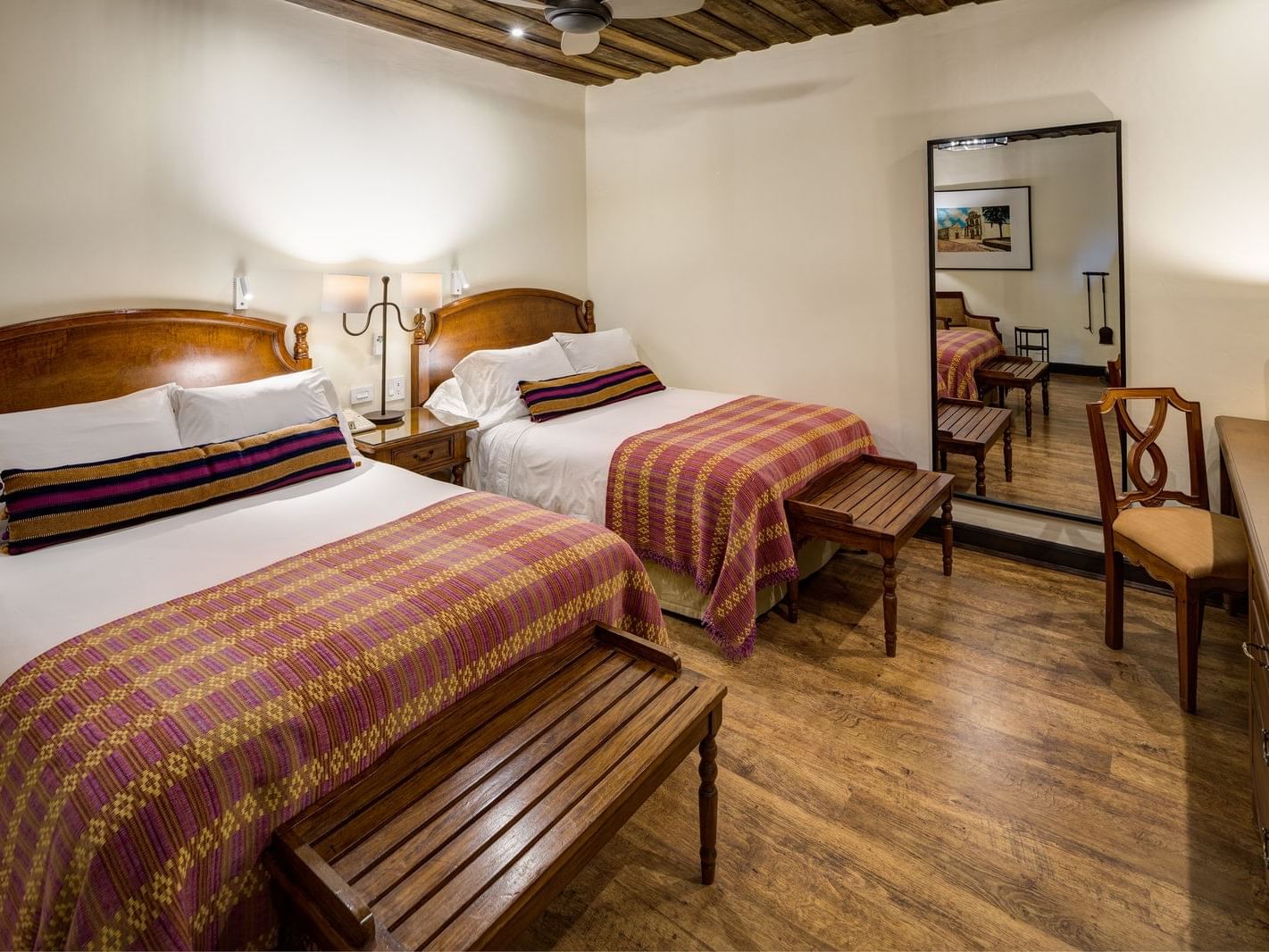 Workspace facing the beds in Deluxe Garden with wooden floors at Porta Hotel Antigua