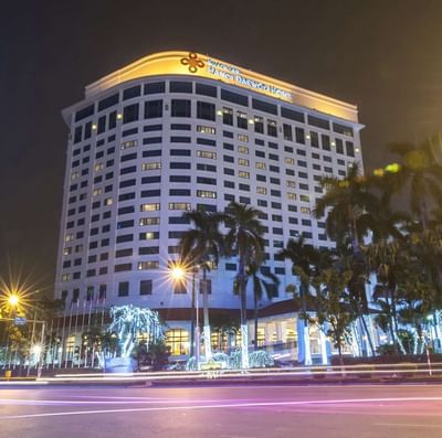 An illuminated building of the Hanoi Daewoo Hotel at night