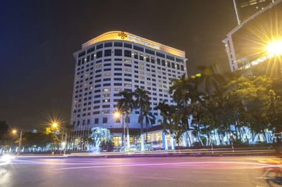 An illuminated building of the Hanoi Daewoo Hotel at night
