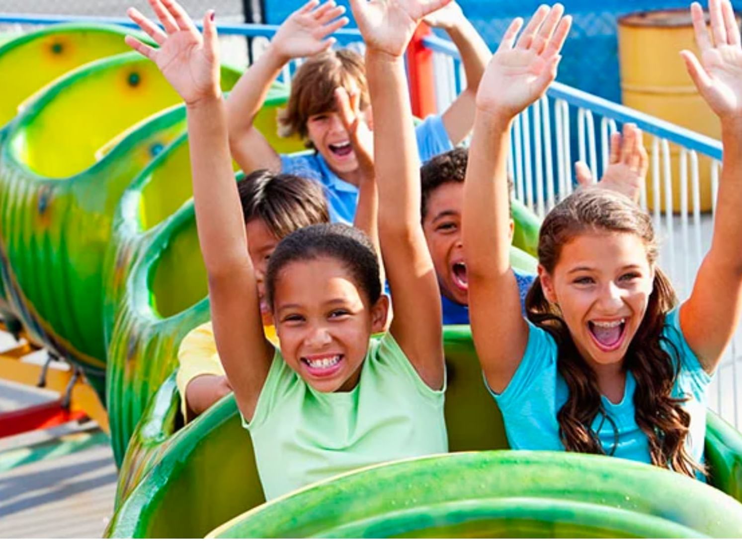 Excited group of kids enjoying a child safe rollercoaster ride at Story Land Park