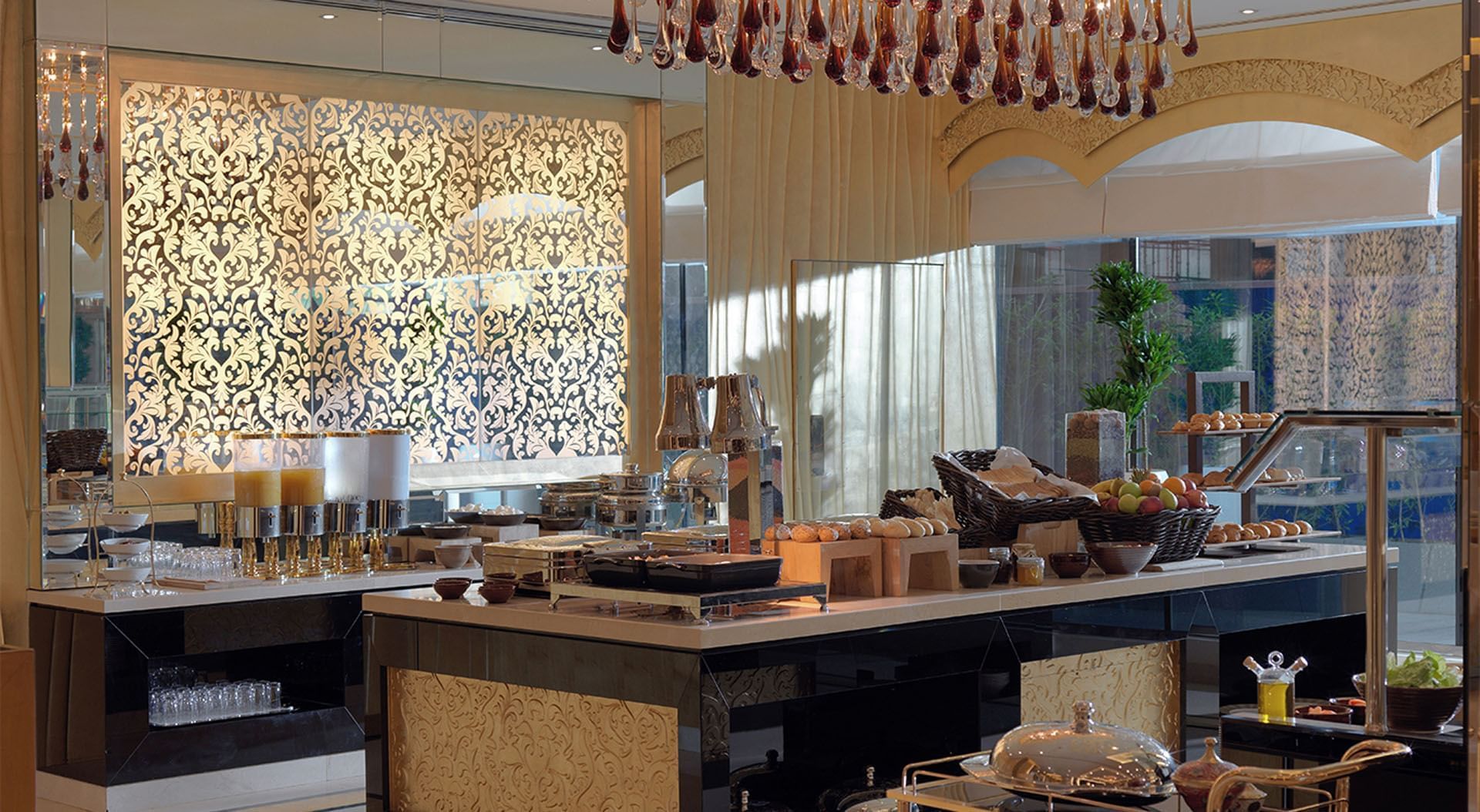 Buffet setup with ornate screen, and hanging glass lights in La Maison, Dubai Mall restaurants at DAMAC Maison Mall Street