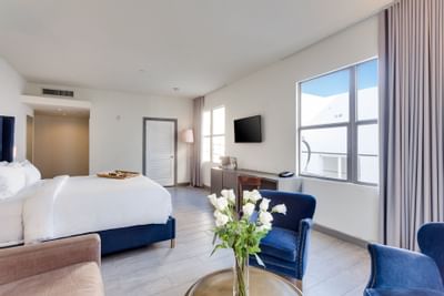 Bedroom & living area in Deluxe King at Clinton Hotel South 