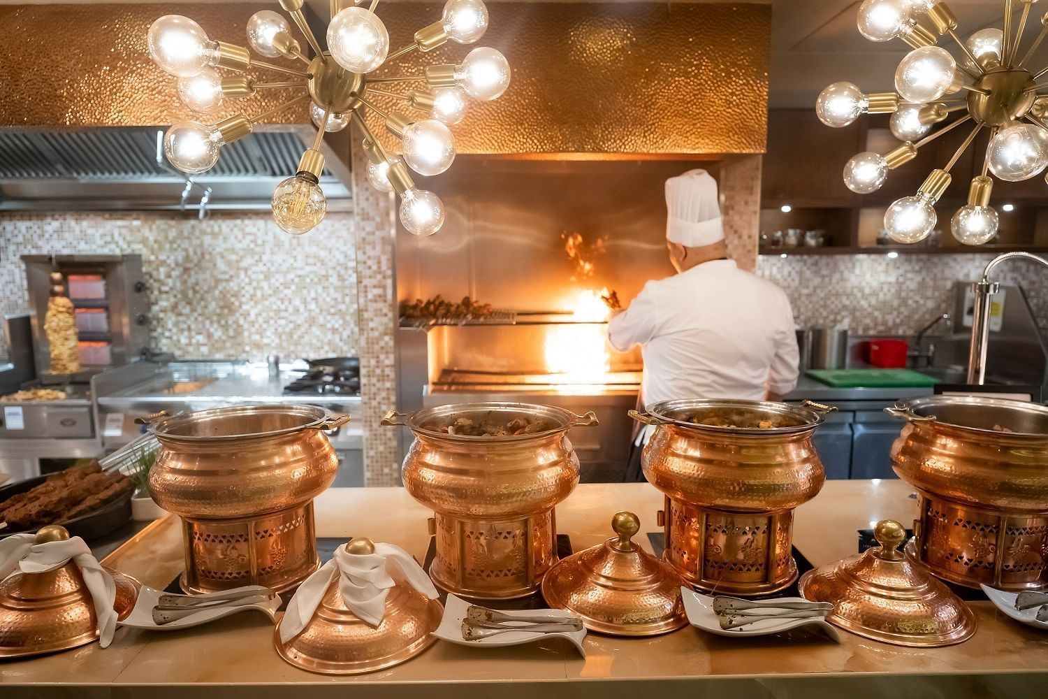 Chef grilling meats in The Stage's Iftar buffet area at Paramount Hotel Dubai