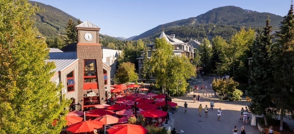 Outdoor restaurant patios beneath the clock tower in Whistler Village.
