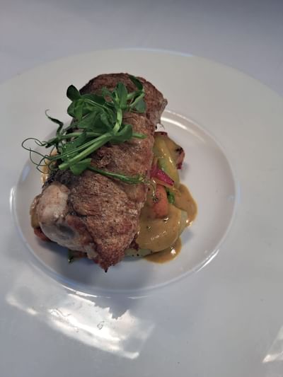Close-up of a Pork Belly dish in a menu at Orsett Hall Hotel